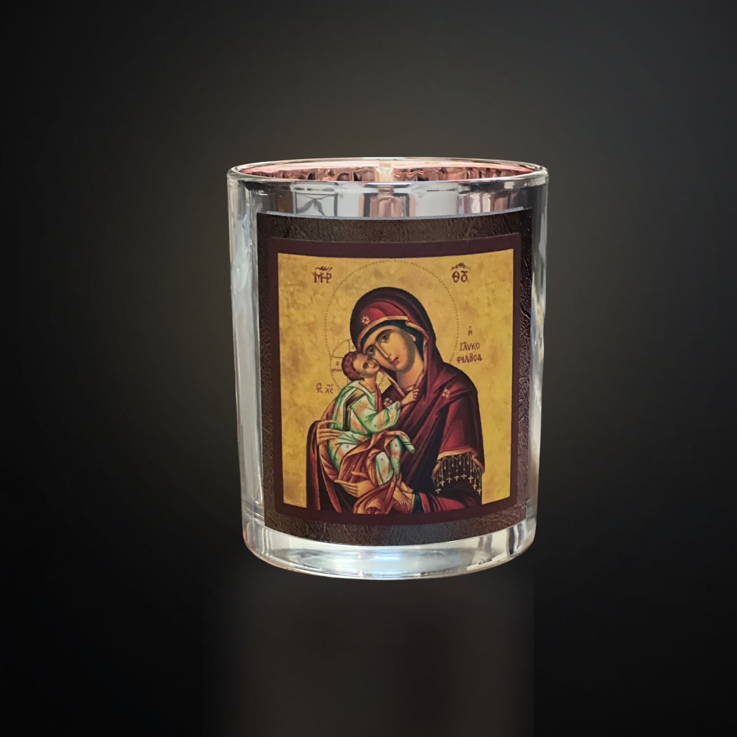 Silver Livani candle with Mary icon on a dark gradient background with soft cool lighting