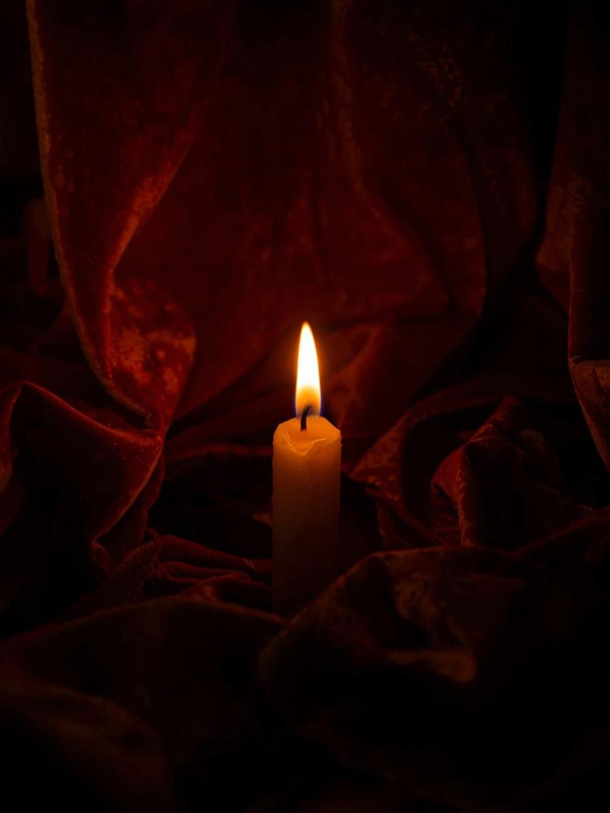 The Candle Chapter collection banner — deep amber glow on crimson velvet, cinematic and ritualistic atmosphere.