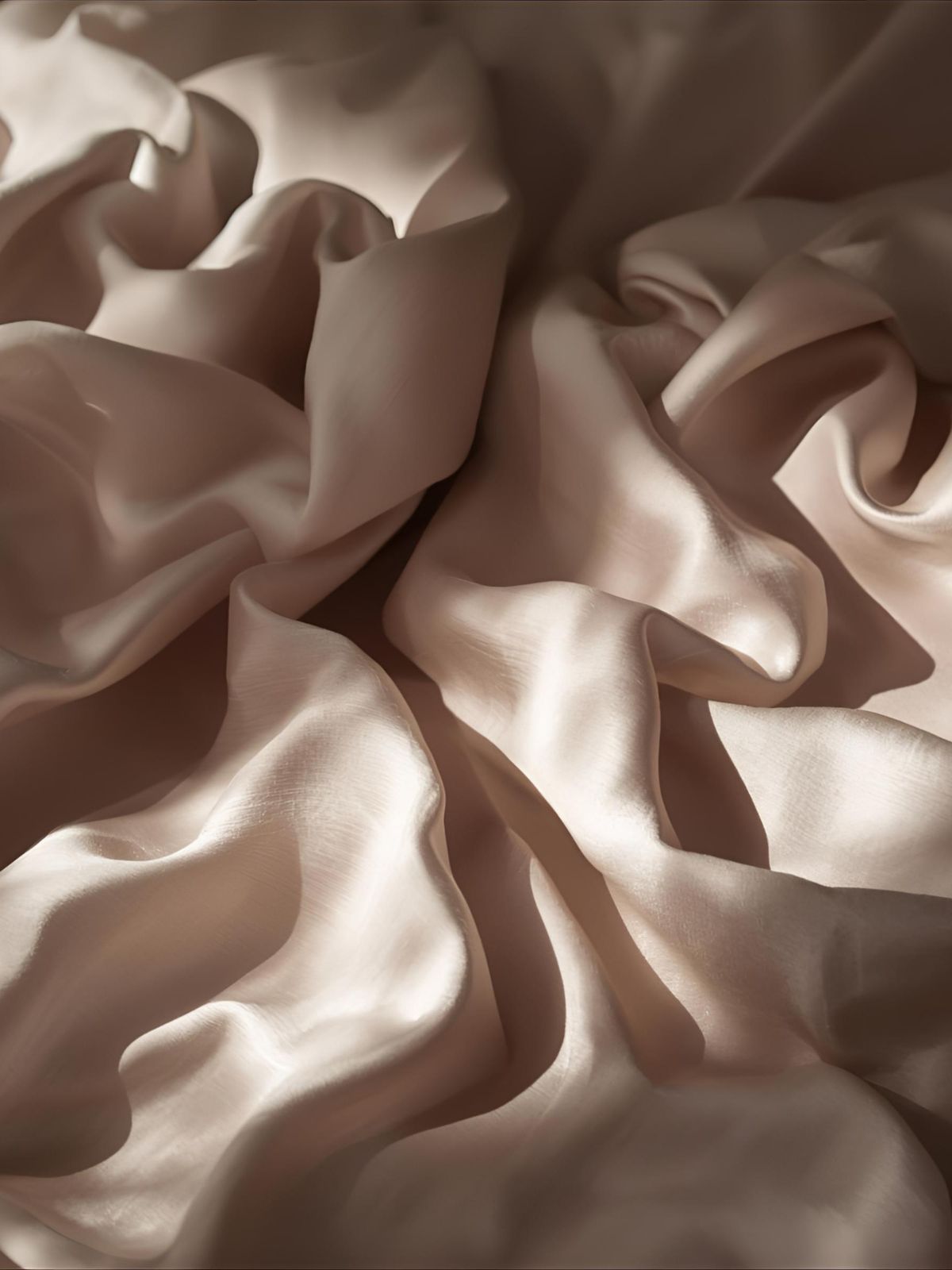 Soft folds of silk in neutral tones — evoking grace, depth, and the quiet strength of for her extrait de parfum.