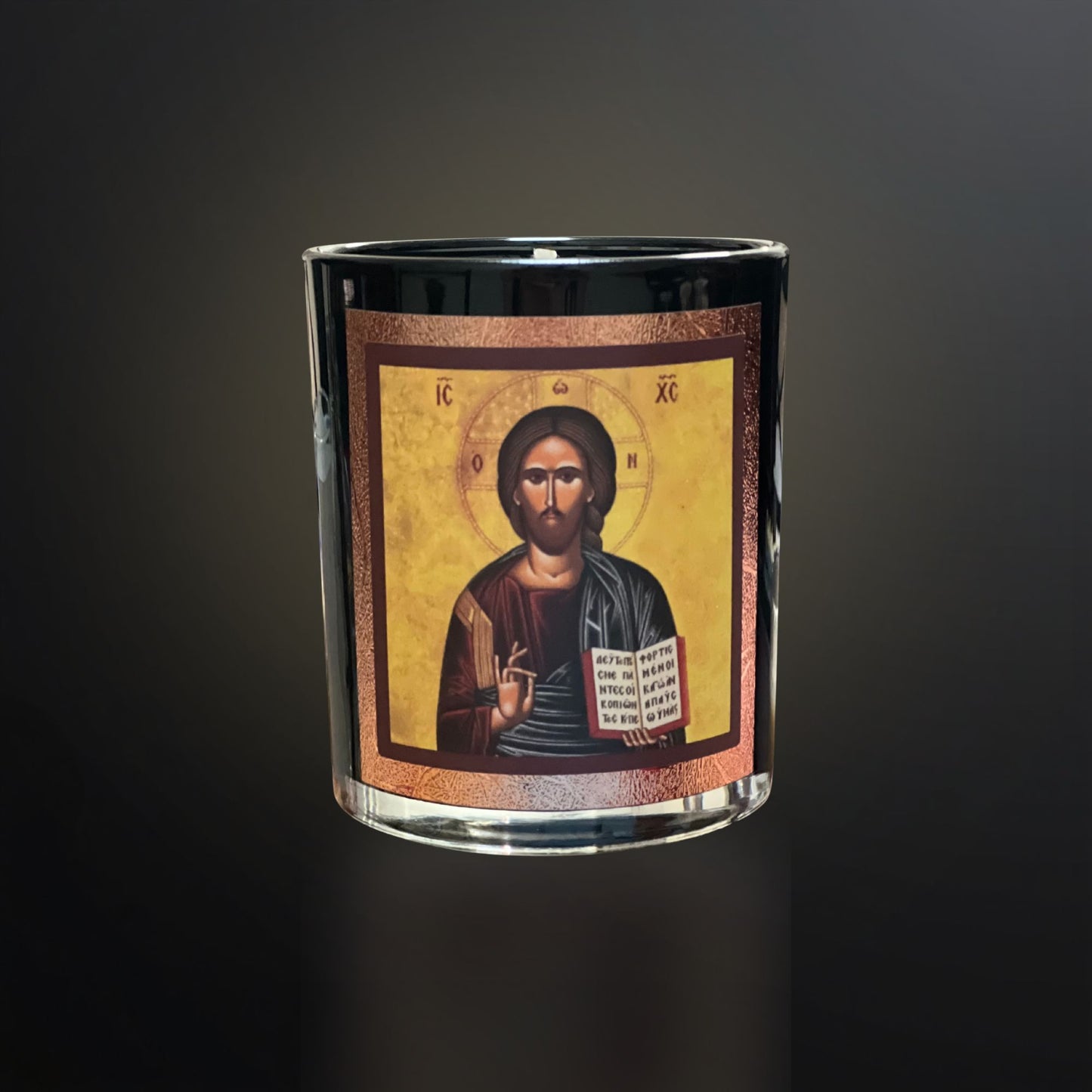 “Black Livani candle with Christ icon on a dark gradient background with soft warm lighting.”