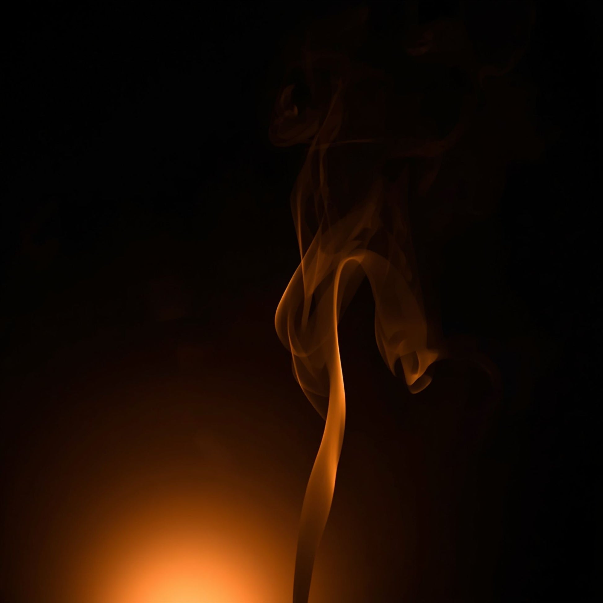 Abstract dark scene with warm golden light and a single plume of illuminated incense smoke rising against a black background, representing the Black Livani candle mood.”