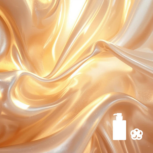 Golden satin fabric with soft folds and body‑wash and loofah icons in the corner.