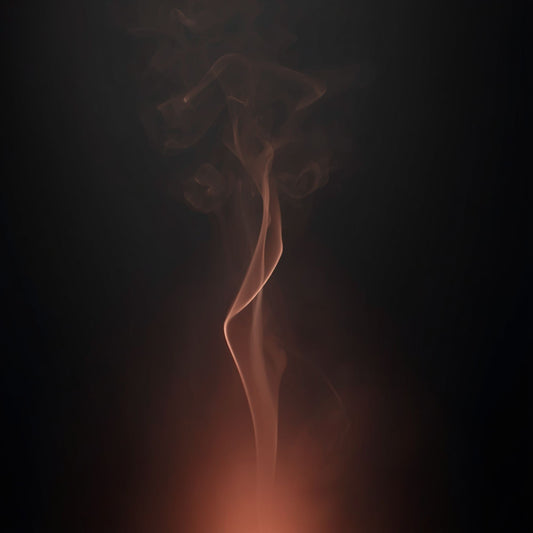 Rose‑Gold Livani candle hero image with warm blush glow and rising smoke on a dark background.