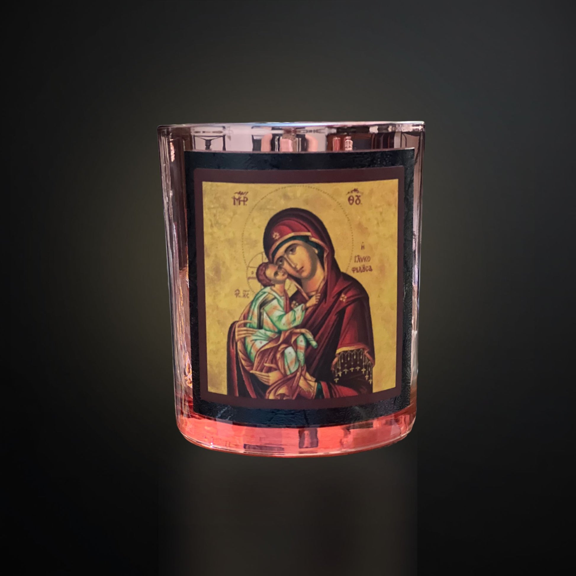 Rose‑Gold Livani candle with Mary icon, rose‑gold vessel and black framing on a dark gradient background