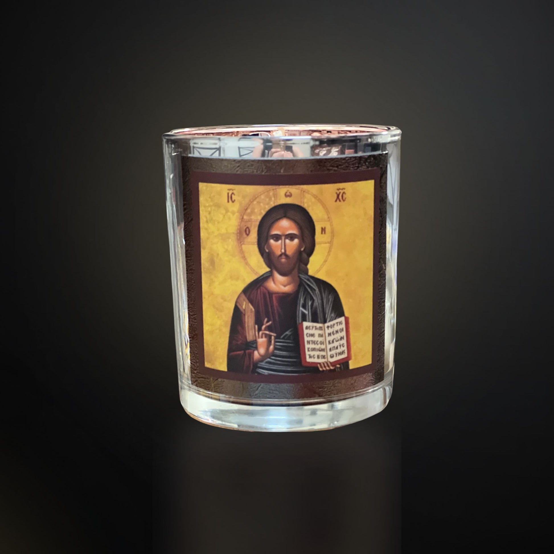 Silver Livani candle with Christ icon on a dark gradient background with soft cool lighting.